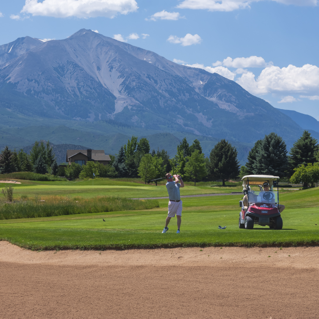 Man golfing with Sopris in the background.